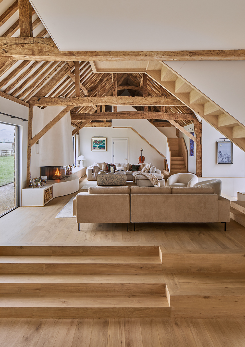 Contemporary sitting room in restored barn with staircase