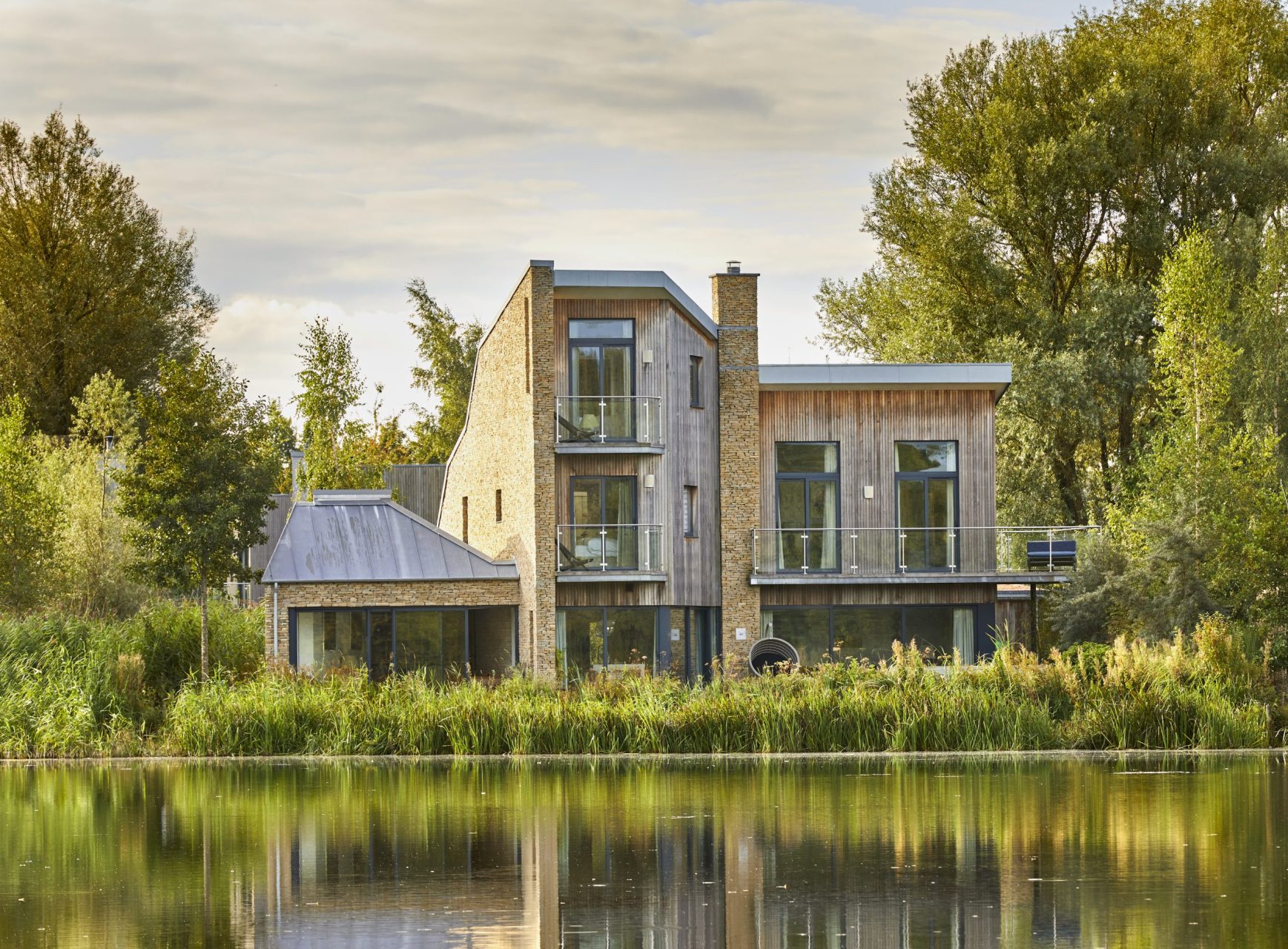 Contemporary lakeside home with wooden cladding, stone work and glazing, the house has a view over the lake