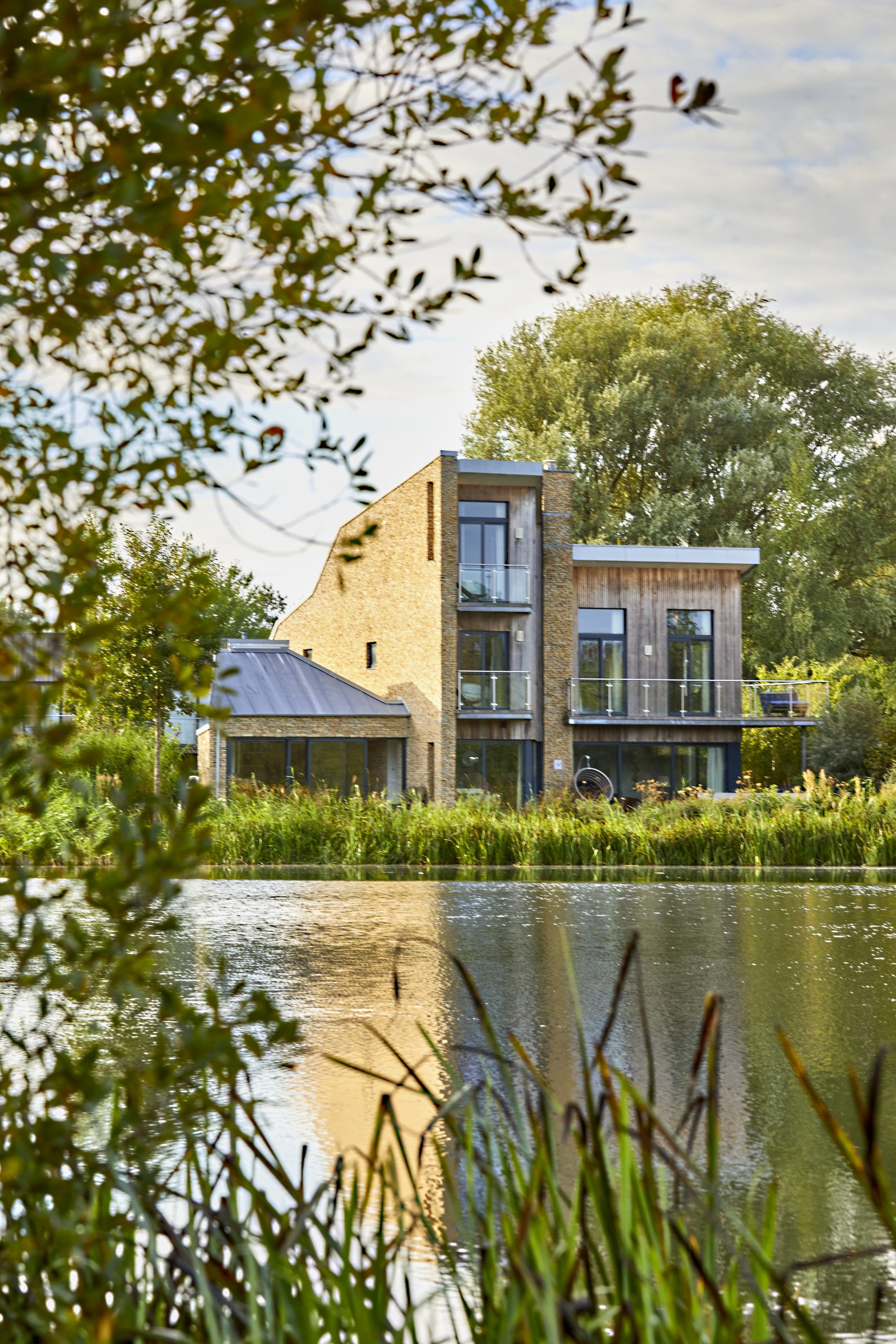 Contemporary lakeside home with wooden cladding, stone work and glazing, the house has a view over the lake