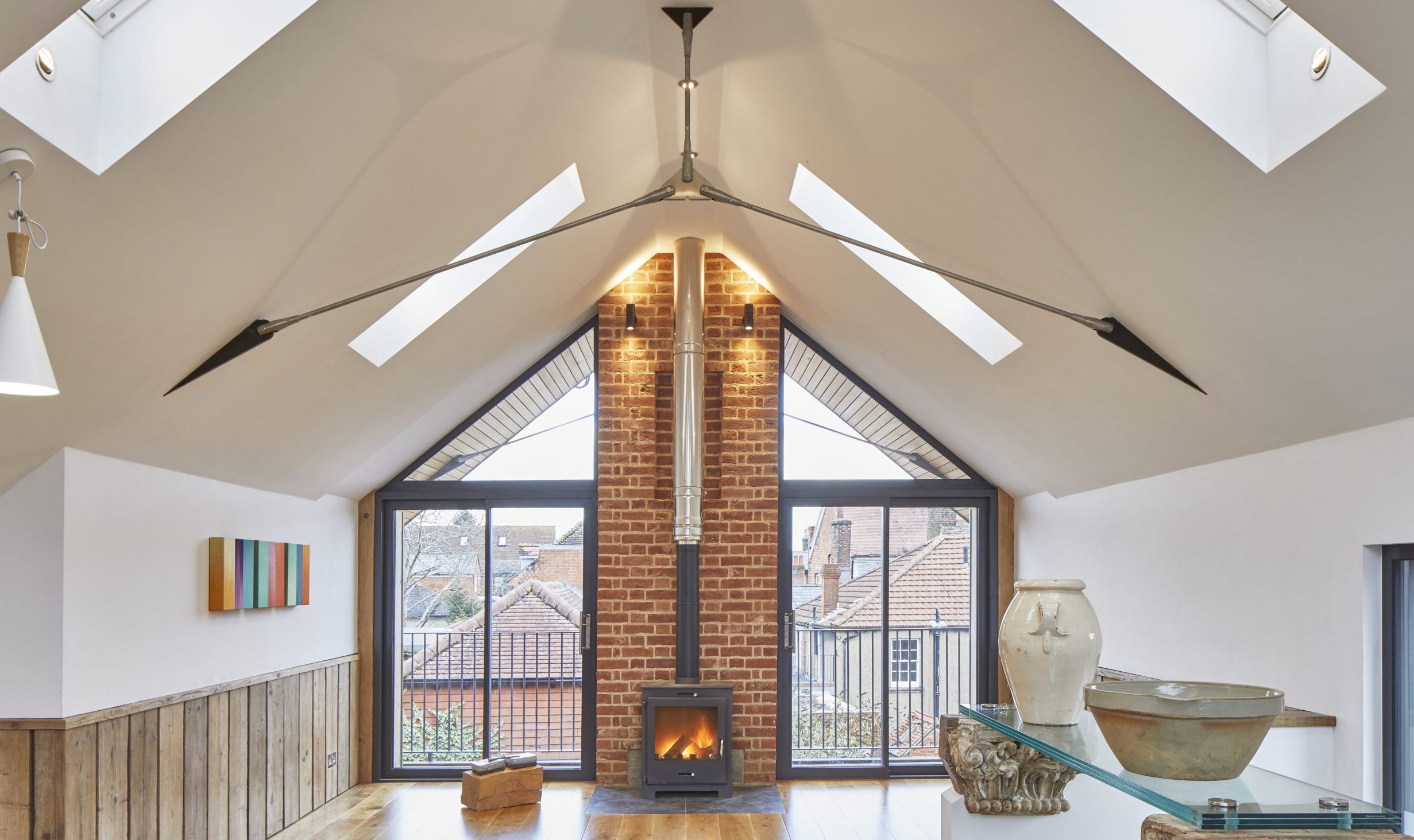modern loft apartment with wood floor, woodburning stove and glazing