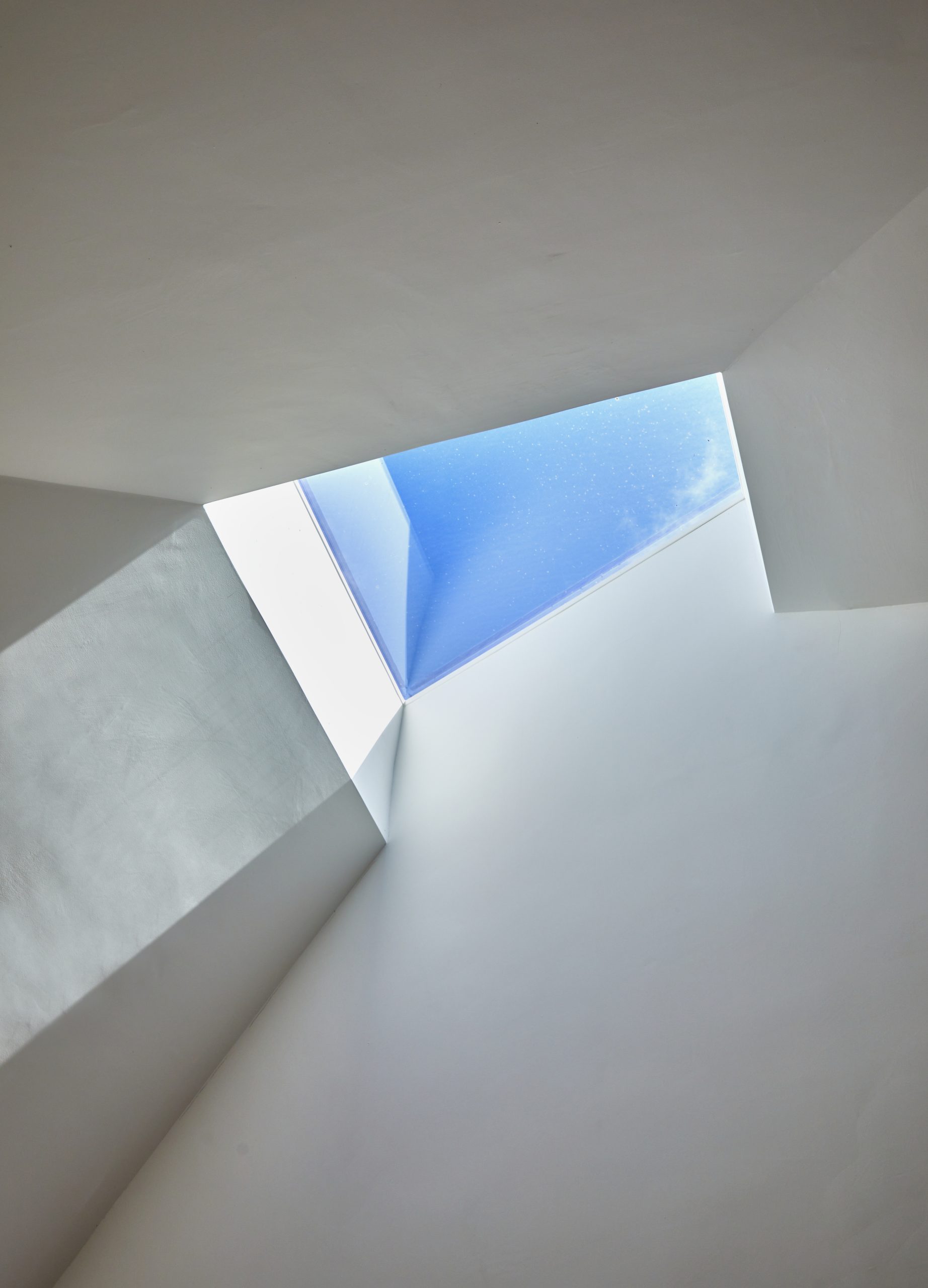 square roof light with clouds and sky behind